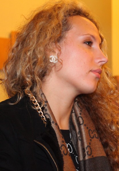 a beautiful young curly fair-haired woman in a Catholic Church, photo 2