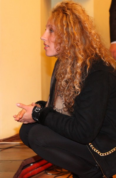 a beautiful young curly fair-haired woman in a Catholic Church, photo 3