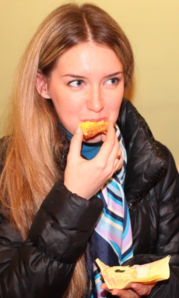 a charming beautiful young fair-haired long-haired woman eating something, photo 7