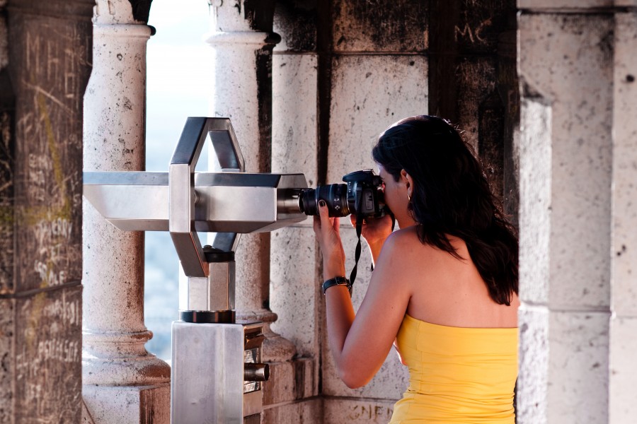 A woman taking picture with the help of a telescope, Montmartre, Paris 2011
