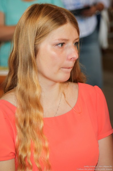 a young blond woman in a Catholic church in July 2016, picture 1