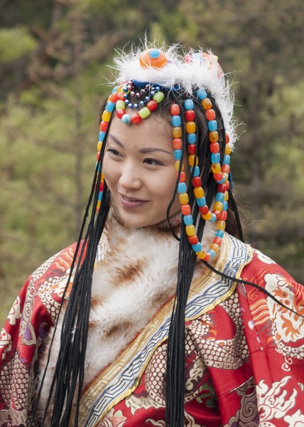 a woman in a traditional costume in Jiuzhaigou Sichuan, China