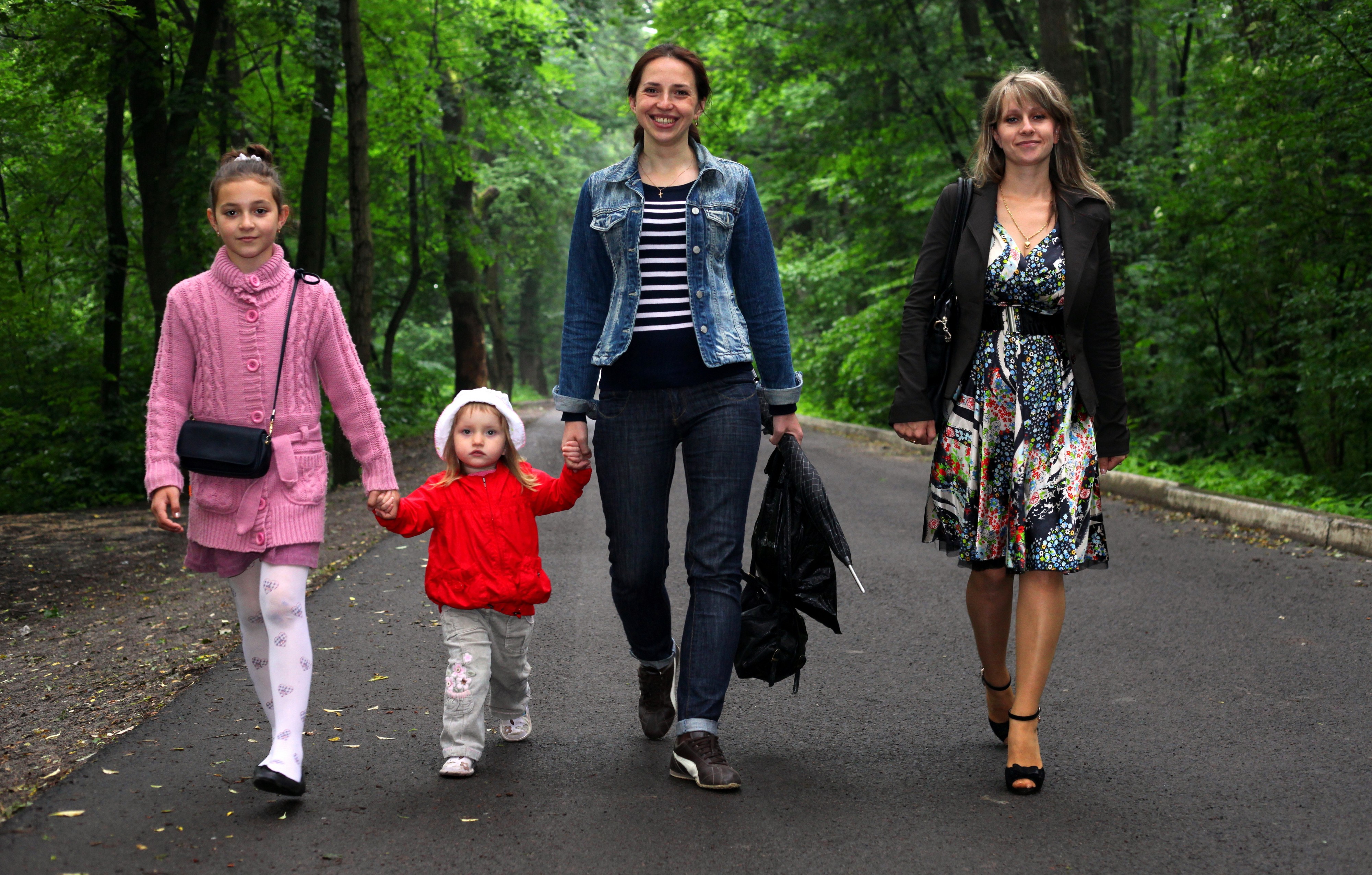 four young Catholic females walking through a park in June 2013