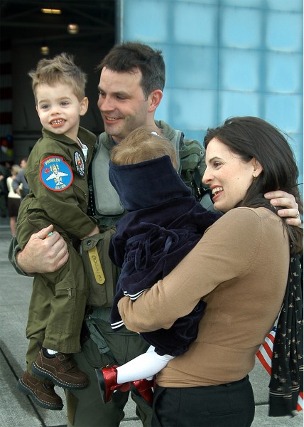 US Navy 050301-N-3770P-002 An air crew member greets his loved ones after returning from a deployment to the Western Pacific Ocean aboard USS Abraham Lincoln (CVN 72)
