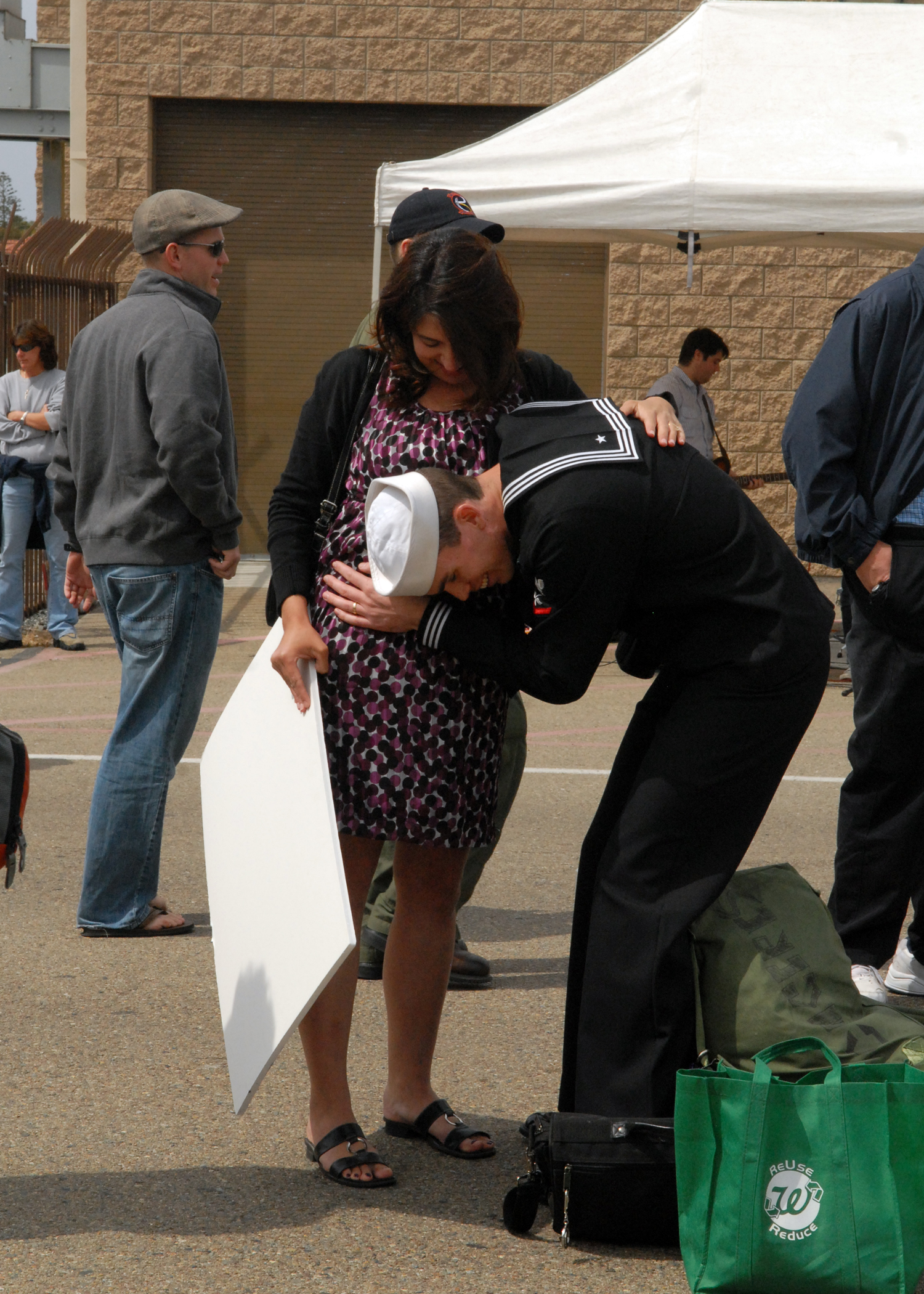 US Navy 110319-N-CH132-106 Aviation Machinist's Mate 3rd Class Ryan Caceres reunites with his wife after a six-month deployment aboard the aircraft