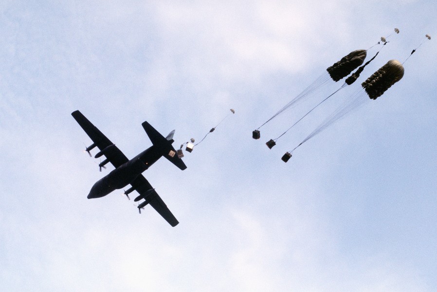 A C-130 Hercules aircraft drops supplies by parachute to troops during Exercise Volant Shield DF-ST-89-06582