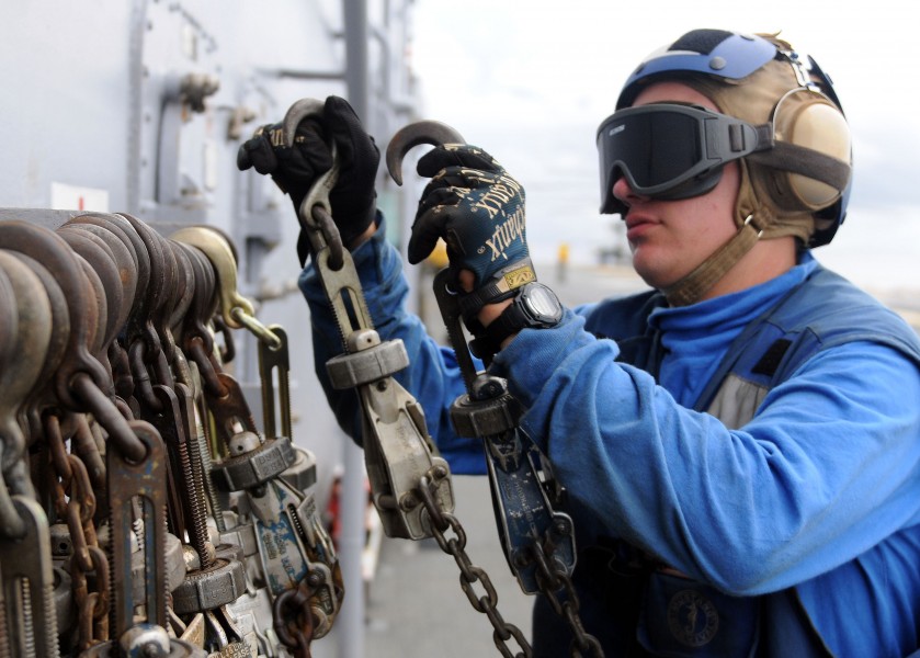 Defense.gov News Photo 100913-N-5538K-213 - U.S. Navy Airman Recruit Jeremy J. New stows tie-down chains after removing them from a CH-46E Sea Knight helicopter aboard the USS Essex LHD 2 in