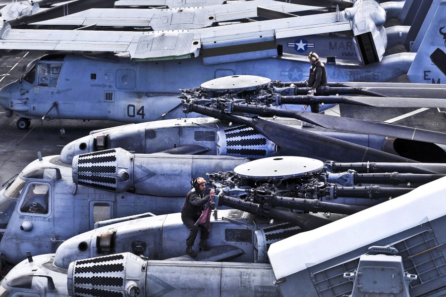 Defense.gov News Photo 120404-N-VE788-036 - U.S. Marines perform maintenance on two CH-53E Sea Stallion helicopters aboard the amphibious assault ship USS Iwo Jima underway in the Atlantic