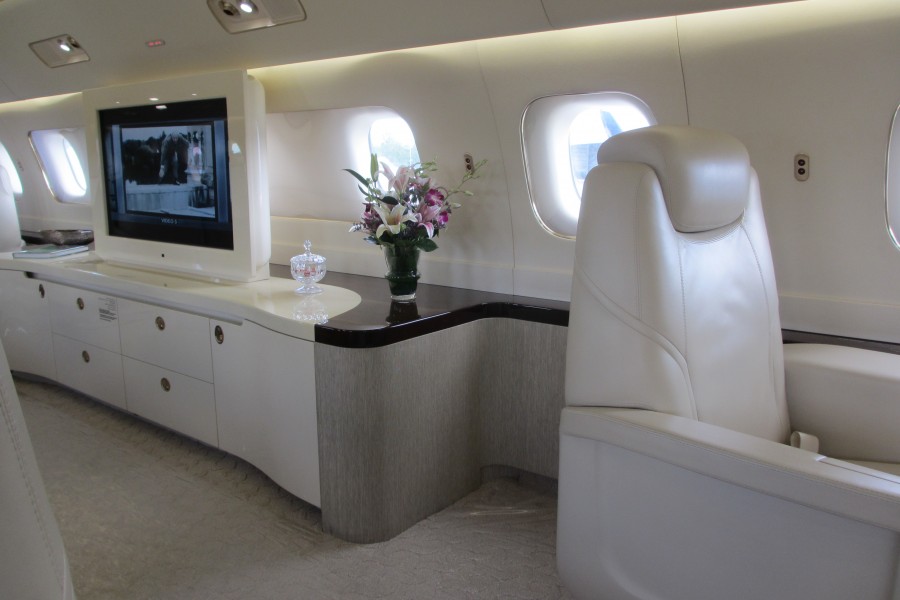 Embraer Lineage 1000 interior with tv and credenza