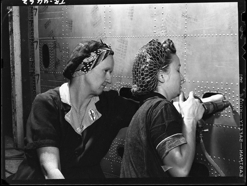 Inside the Douglas aircraft plant at El Segundo, Cal. Women riveters working on a wing panel of an SBD. - NARA - 520742