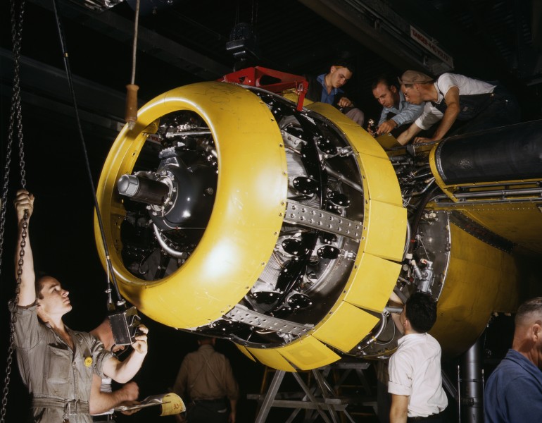 Mounting motor on a Fairfax B-25 bomber, at North American Aviation, Inc., plant in Inglewood, Calif