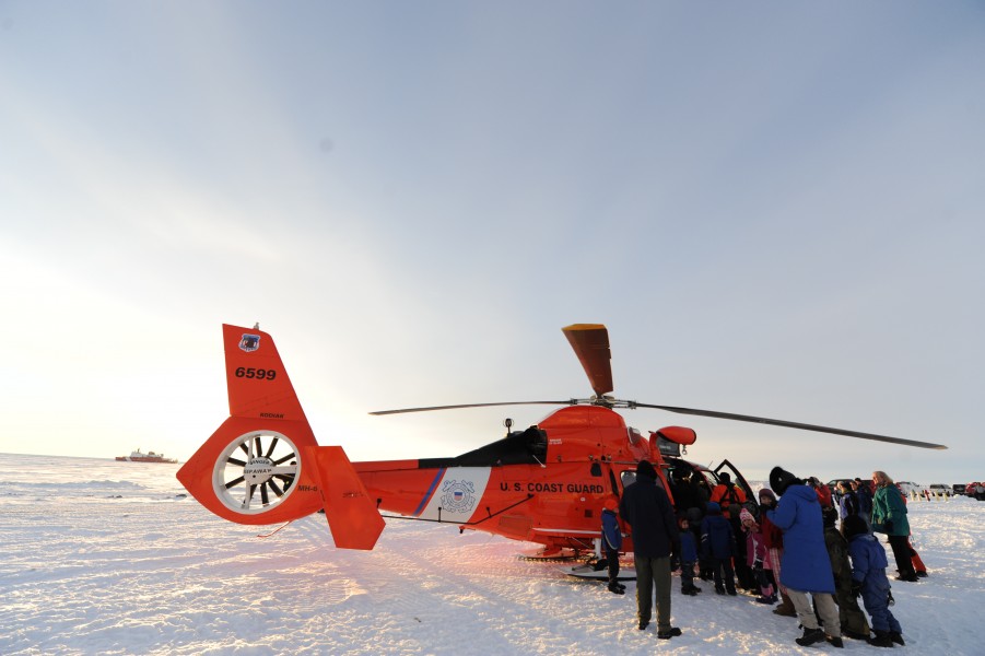 Nome, Alaska, residents surround a U.S. Coast Guard MH-65 Dolphin helicopter in Nome Jan 120118-G-YE680-083
