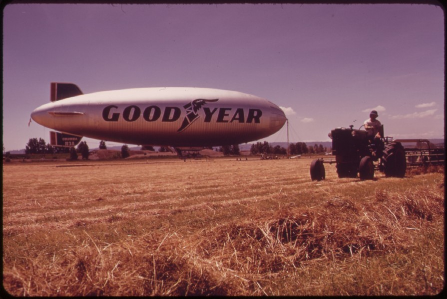 THRESHING AT THE PIERSON PARK AIRFIELD, GOODYEAR BLIMP IN BACKGROUND - NARA - 548014