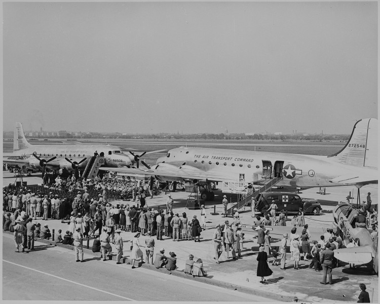 Two airplanes and a crowd gathered for the christening by Bess Truman of the airplanes. - NARA - 199098