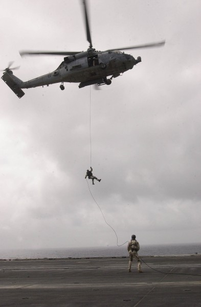 US Navy 030824-N-6536T-003 Personnel from the Explosive Ordnance Disposal Mobile Unit Eleven Detachment One (EOD MU-1 DET 1), practice exiting out of an SH-60 Seahawk helicopter