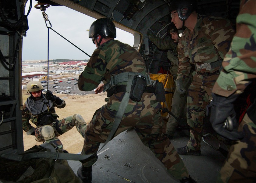 US Navy 050216-N-4374S-003 A Sailor assigned to Explosive Ordnance Disposal Mobile Unit Two (EODMU-2), rappels out of a UH-3H Sea King helicopter