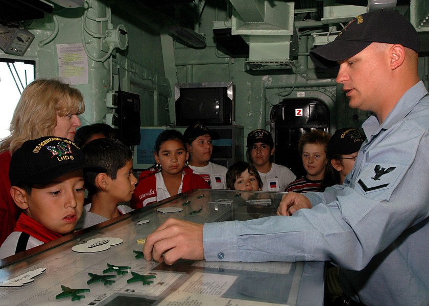 US Navy 070330-N-5567K-084 An aviation boatswain^rsquo,s mate describes take off and landing planning and tracking procedures to a group of 5th grade students from Gerald R. Ford Elementary 