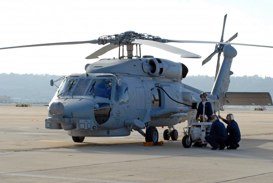 US Navy 071002-N-9604C-031 Sailors assigned to Helicopter Maritime Strike Squadron (HSM) 71 service a MH-60R Seahawk