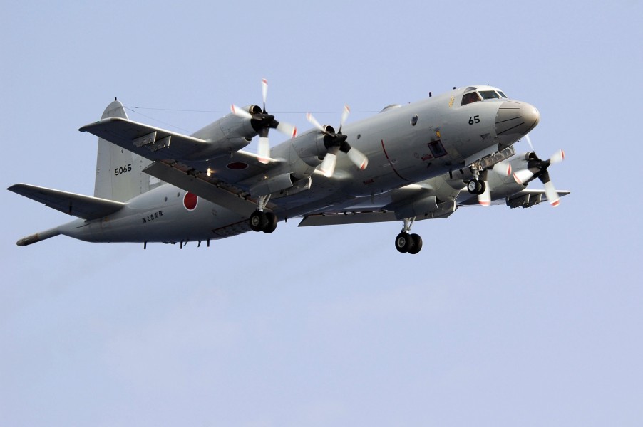 US Navy 071116-N-5387K-043 A Japan Maritime Self-Defense Force (JMSDF) P-3C Orion flies above the aircraft carrier USS Kitty Hawk (CV 63) during a 19-ship group photo exercise