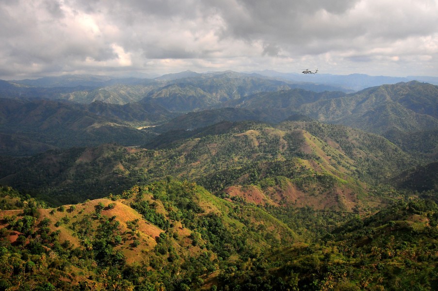 US Navy 100116-N-4774B-971 An SH-60F Sea Hawk helicopter flies over the mountains of Haiti to deliver supplies to those affected by the earthquake