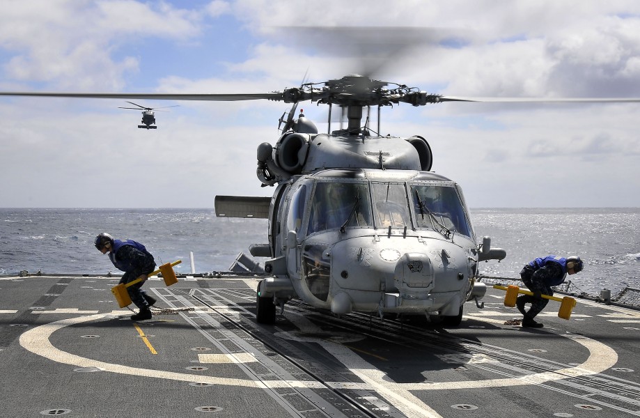 US Navy 100321-N-4774B-132 Sailors remove the chock and chains securing an SH-60F Sea Hawk helicopter assigned to the Red Lions of Helicopter Anti-submarine Squadron (HS) 15