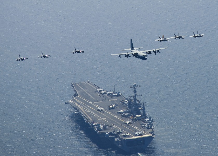 US Navy 100727-N-2013O-063 Marine Corps C-130 Hercules leads a formation of F-A-18C Hornets and A-V-8B Harriers as they fly in formation over USS George Washington (CVN 73)