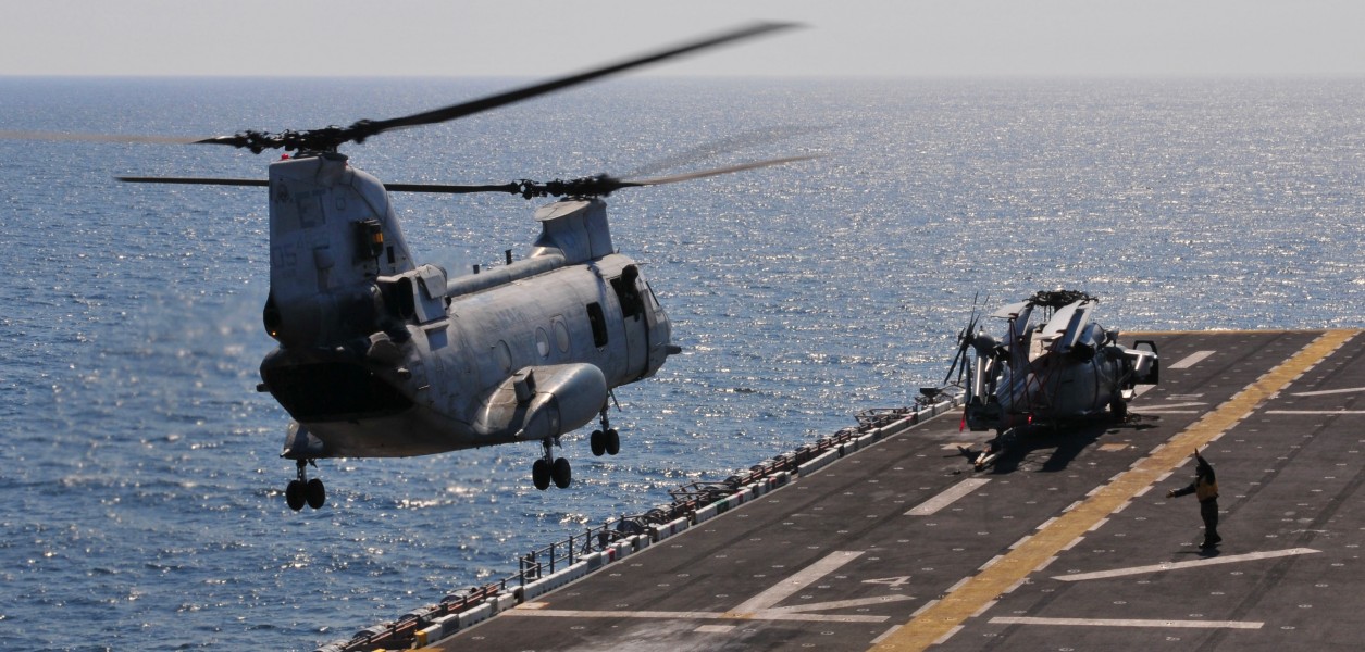 US Navy 110329-N-5538K-217 A CH-46E Sea Knight helicopter carrying humanitarian assistance supplies takes off from the forward-deployed amphibious 