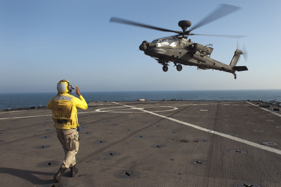 US Navy 120128-N-KS651-305 A Sailor signals a helicopter to land on the flight deck of USS Pearl Harbor