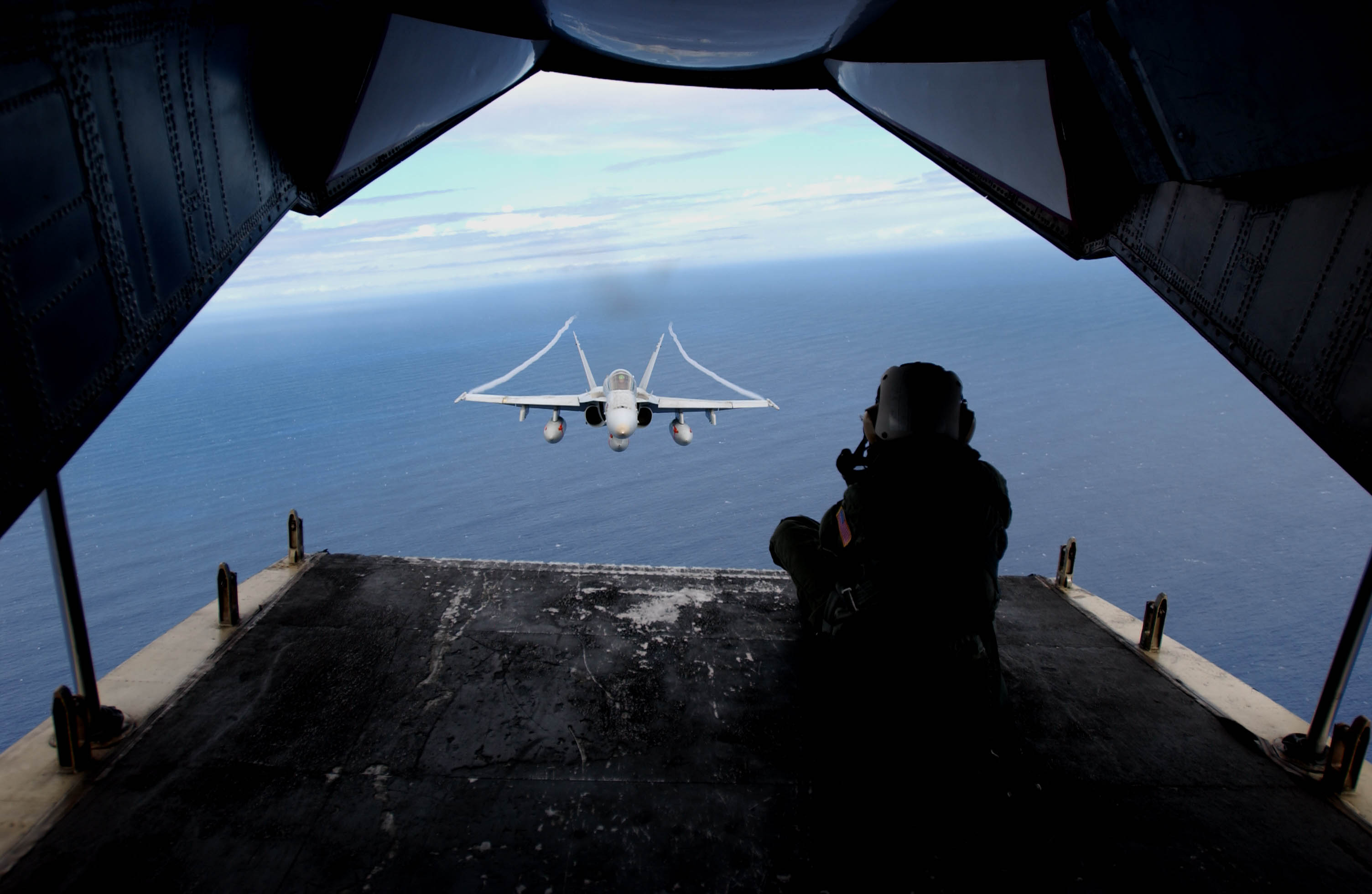 US Navy 031025-N-9411J-010 Photographer^rsquo,s Mate 3rd Class Beth Thompson, from San Francisco, Calif., photographs an F-A-18 Hornet