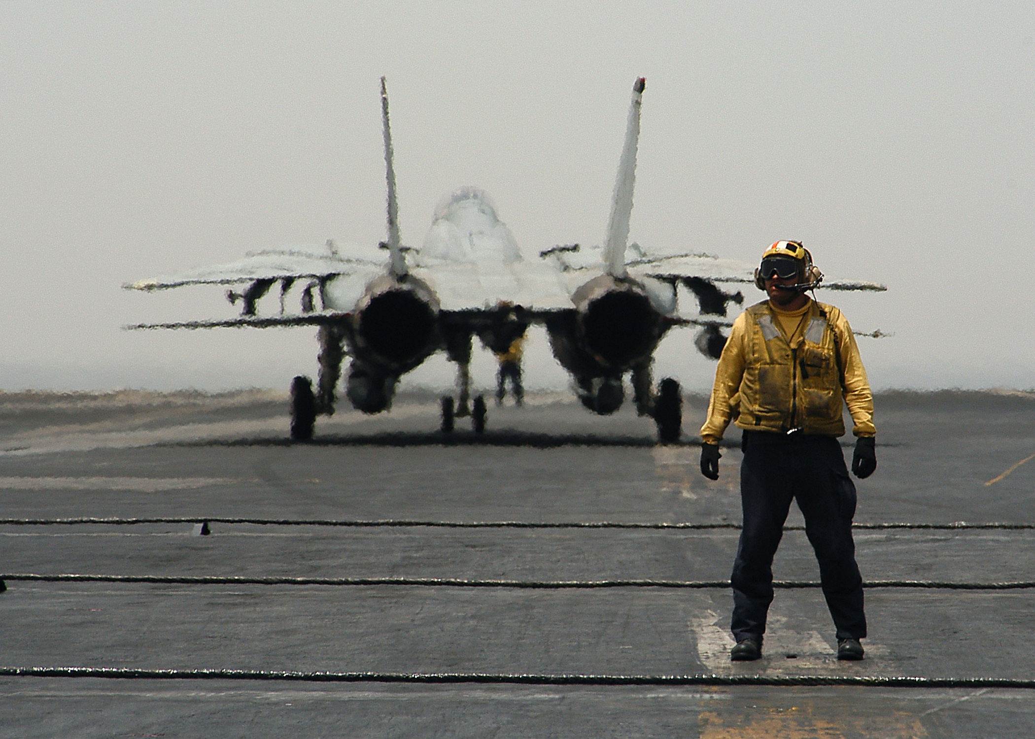 US Navy 040517-N-3986D-027 Aviation Boatswain's Mate 1st Class Lester Cruz of Lake Charles, La., awaits the next aircraft to direct to one of four catapults on the flight deck aboard USS George Washington (CVN 73)