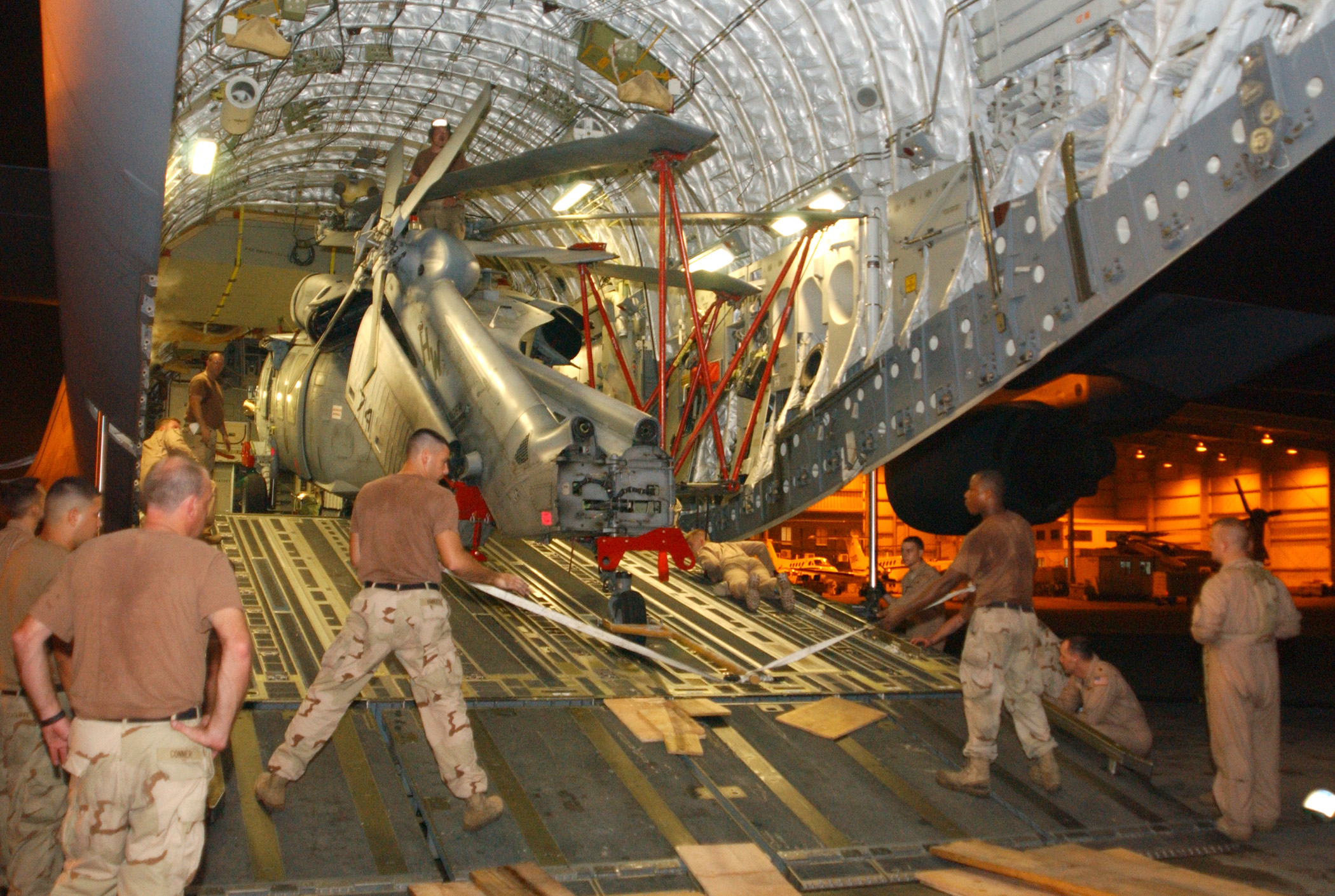 US Navy 051015-N-5863B-002 U.S. Navy helicopter loaded onto transport aircraft bound for Pakistan earthquake relief efforts