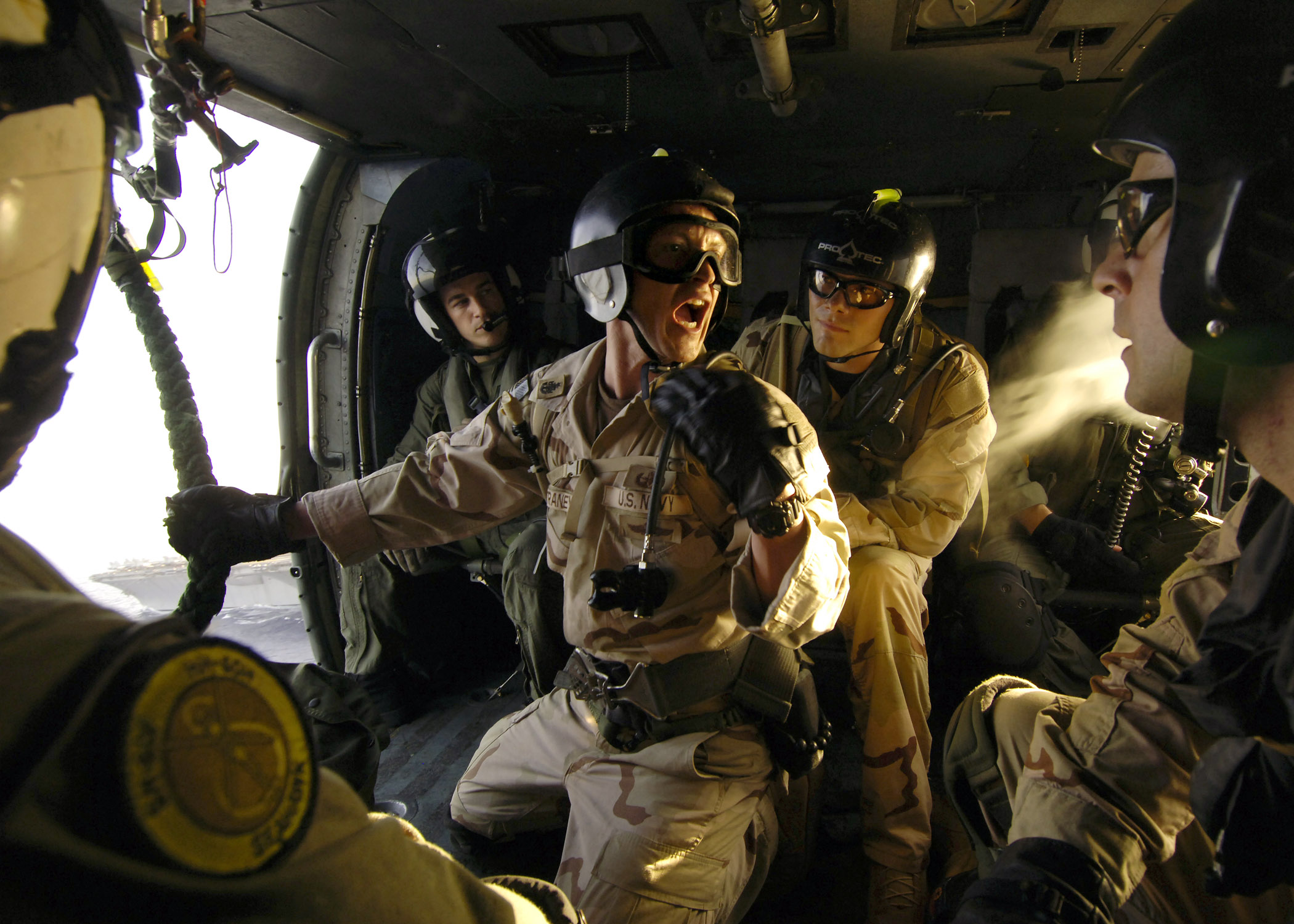 US Navy 060530-N-9742R-215 Senior Chief Electronics Technician Rick Straney, center, assigned to Explosive Ordnance Disposal Mobile Unit Six (EODMU-6) Detachment 14, shouts orders to members