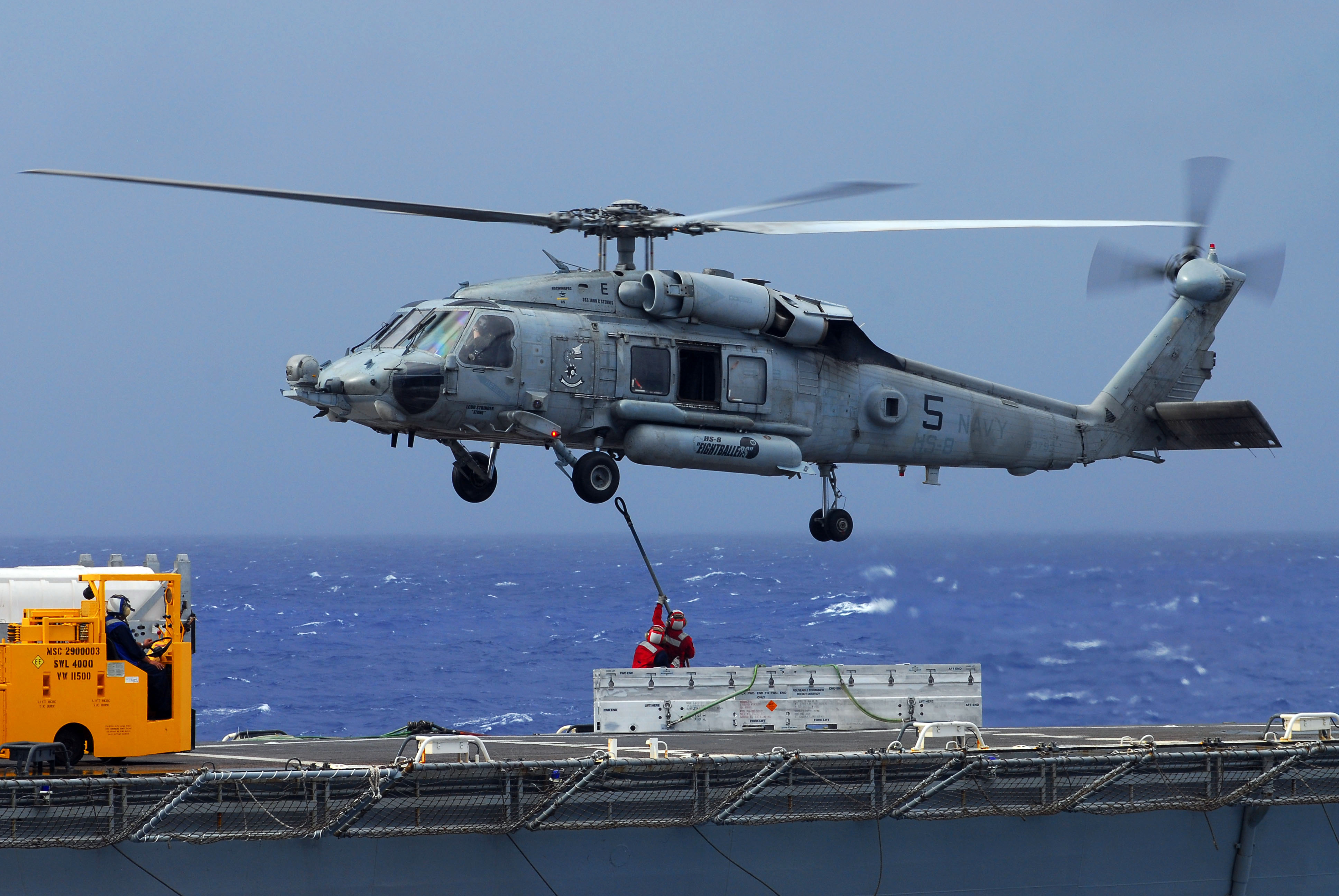 US Navy 070818-N-2659P-131 Sailors aboard Military Sealift Command ammunition ship USNS Flint (T-AE 32) attach a cargo pendant to an HH-60H Seahawk