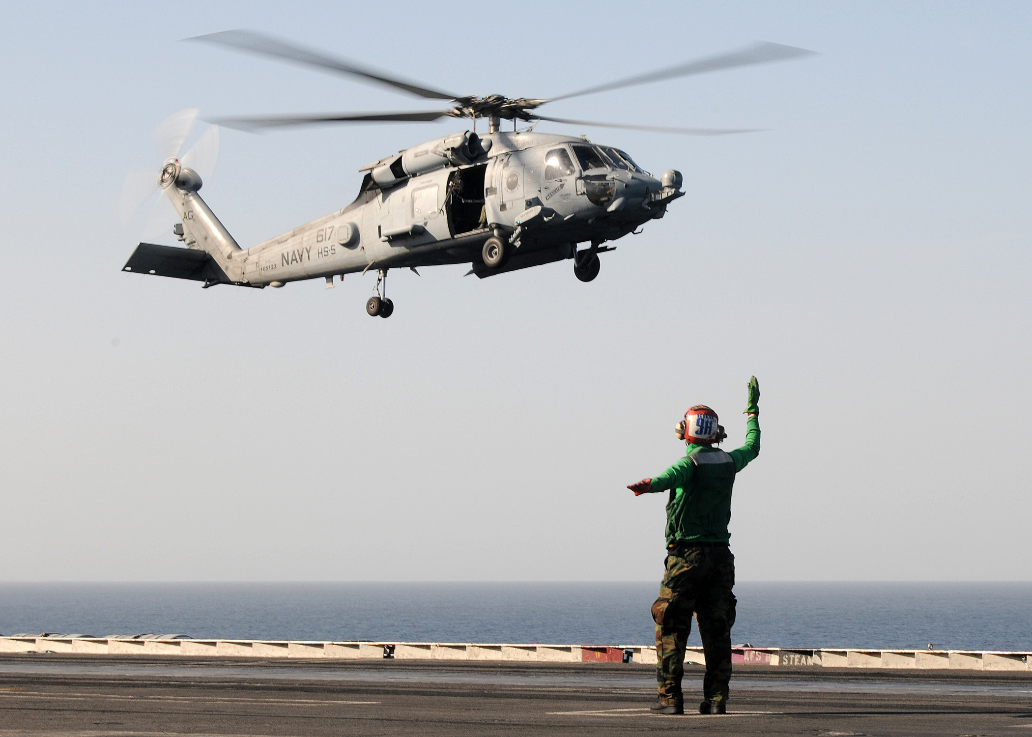 US Navy 100216-N-4236E-032 A Sailor directs the landing of an HH-60H Sea Hawk helicopter assigned to the Nightdippers of Helicopter Anti-Submarine Squadron (HS) 5
