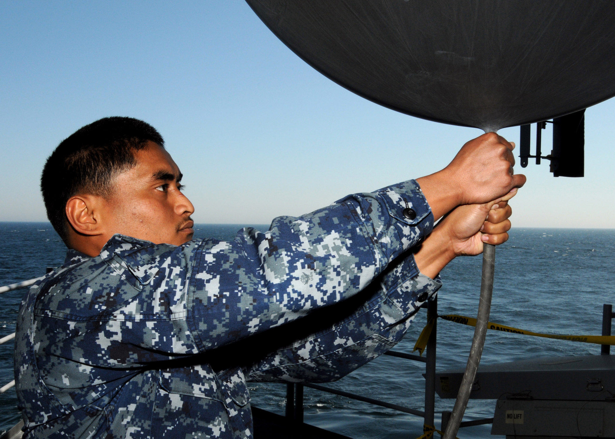 US Navy 100324-N-6509M-016 Aerographer's Mate Airman Apprentice Dante J. Blesoch prepares to release a weather balloon o analyze atmospheric pressure and temperature