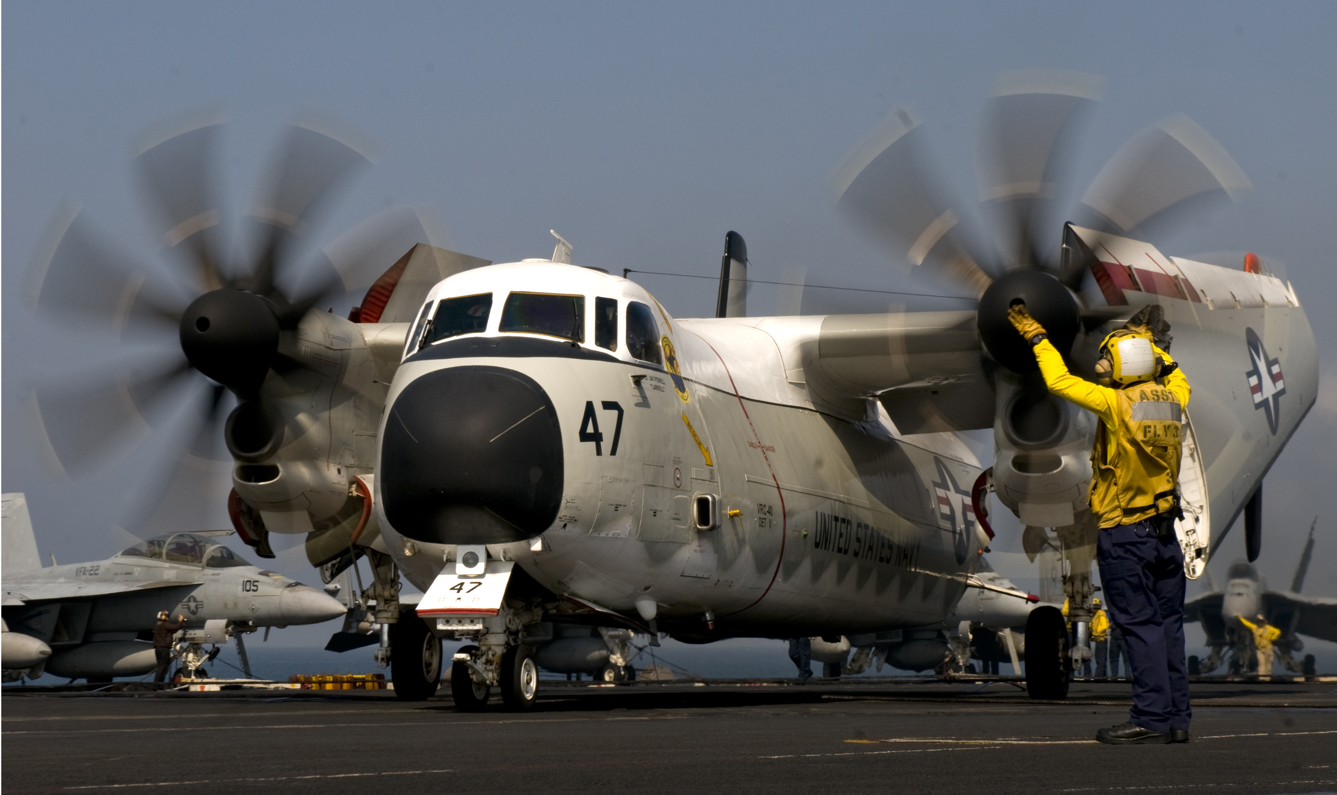 Defense.gov News Photo 110303-N-6320L-091 - Petty Officer 2nd Class Mario Billote guides a C-2A Greyhound assigned to Fleet Logistics Support Squadron 40 aboard the aircraft carrier USS Carl