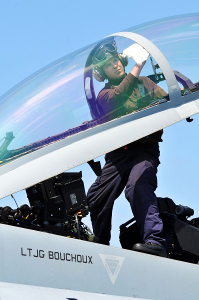 Defense.gov News Photo 110413-N-1004S-222 - Airman Steven Gardner assigned to Strike Fighter Squadron 154 cleans the cockpit window of an F A-18F Super Hornet aboard the aircraft carrier