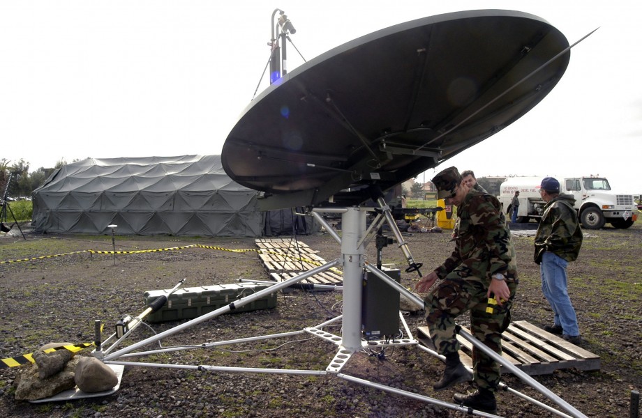 US Navy 030403-N-9693M-004 Electronics Technician 2nd Class Kristian Dillemouth stows a USC-60A satellite dish
