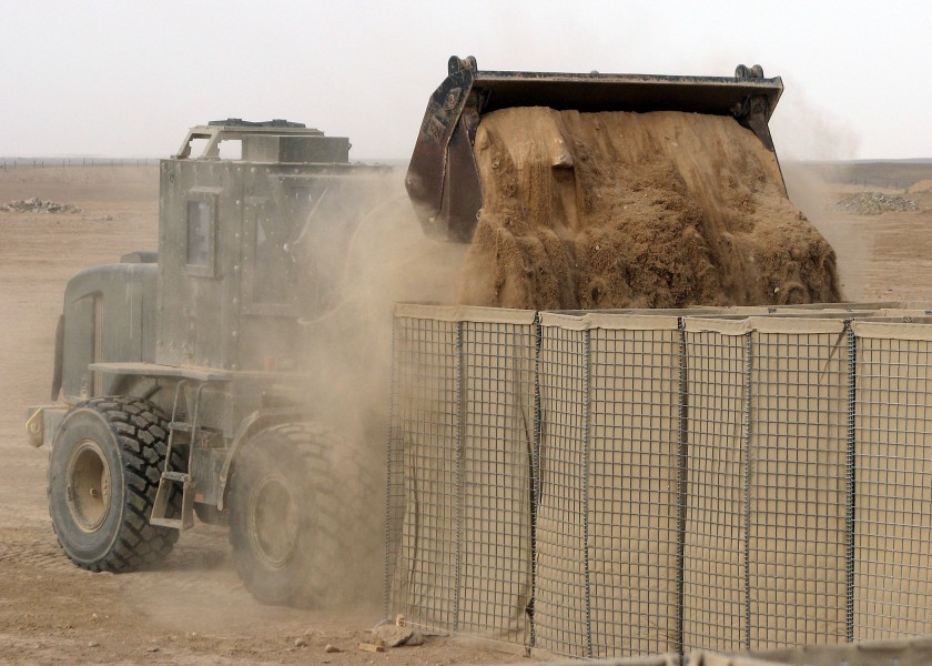 US Navy 090411-N-8547M-011 A Seabee assigned to Naval Mobile Construction Battalion (NMCB) 5 uses an up-armored front end loader to fill HESCO barriers during a project at Camp Bastion