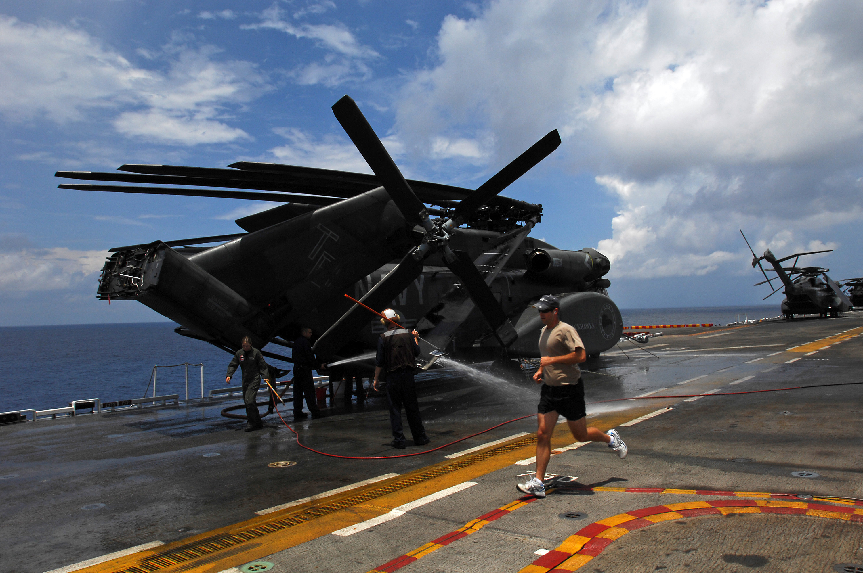 US Navy 080805-N-8335D-027 Sailors assigned to Helicopter Mine Countermeasures Squadron (HM) 15 wash their aircraft