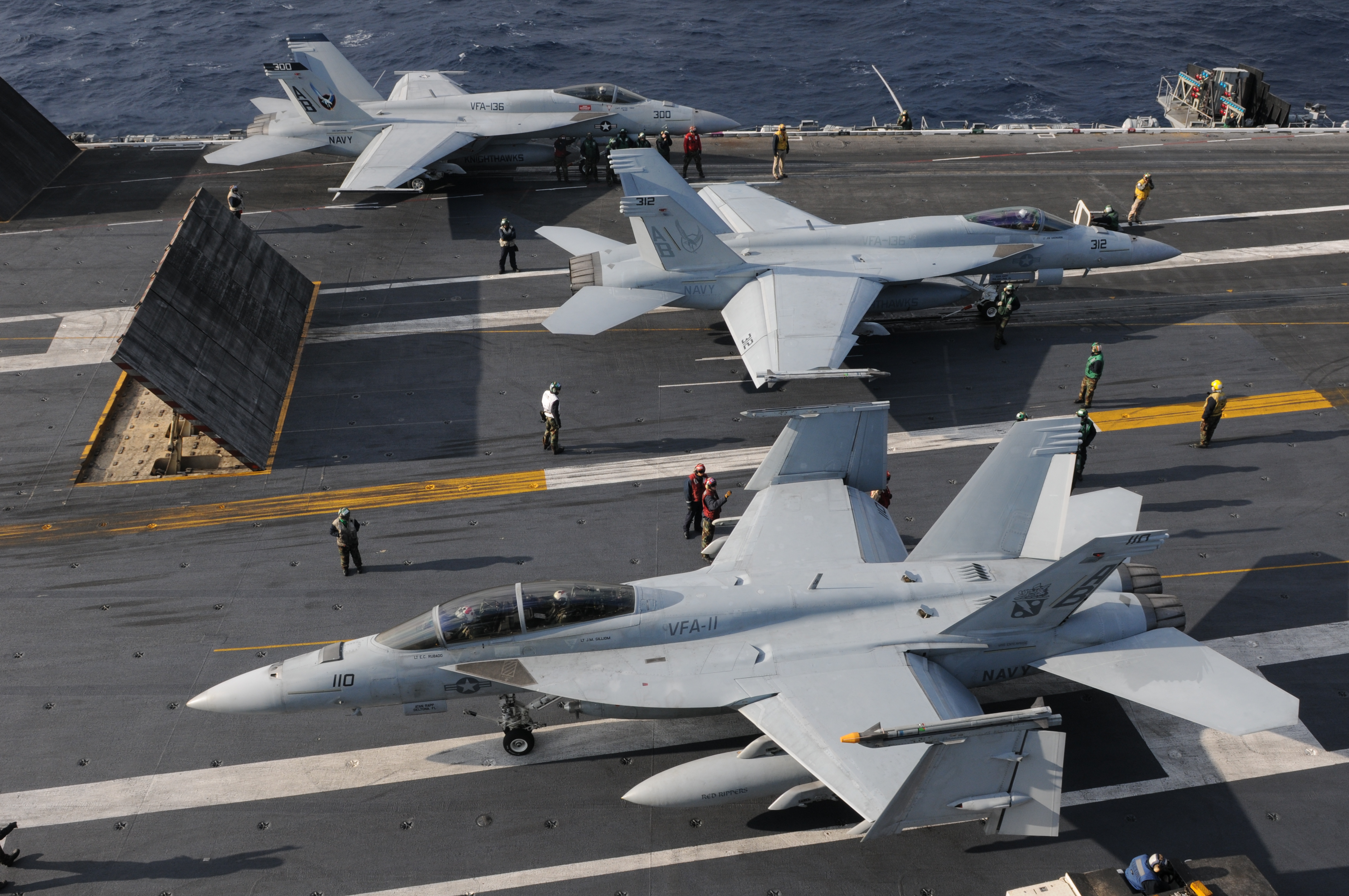 US Navy 101209-N-9693M-009 Two F-A-18E Super Hornets prepare for a catapult assisted launch as an F-A-18E Super Hornet taxis toward the aft of USS 