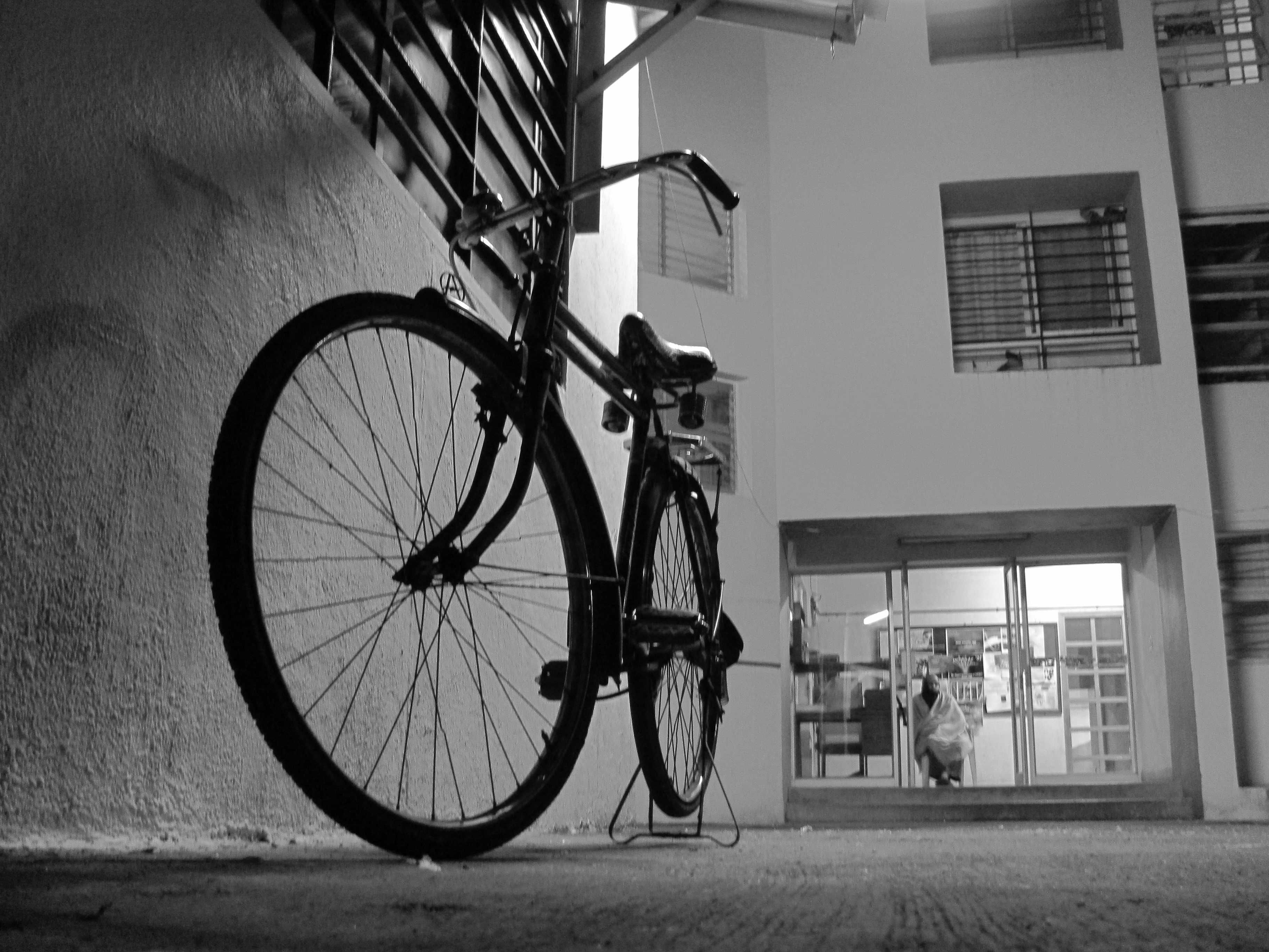 A bicycle parked by a house