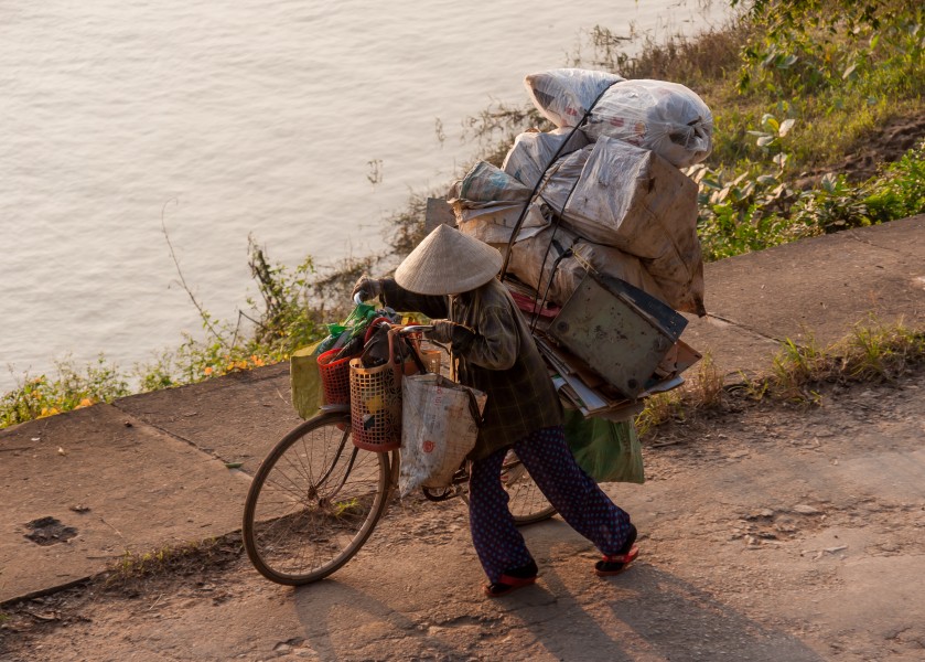 Hue Vietnam A-lady-with-her-bike-transporting-goods-01