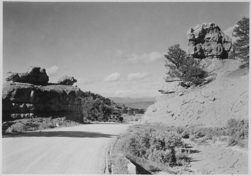 Road to Bryce. Looking west through west entrance of Red Canyon into valley of the Sevier River. The plateau on the... - NARA - 520212