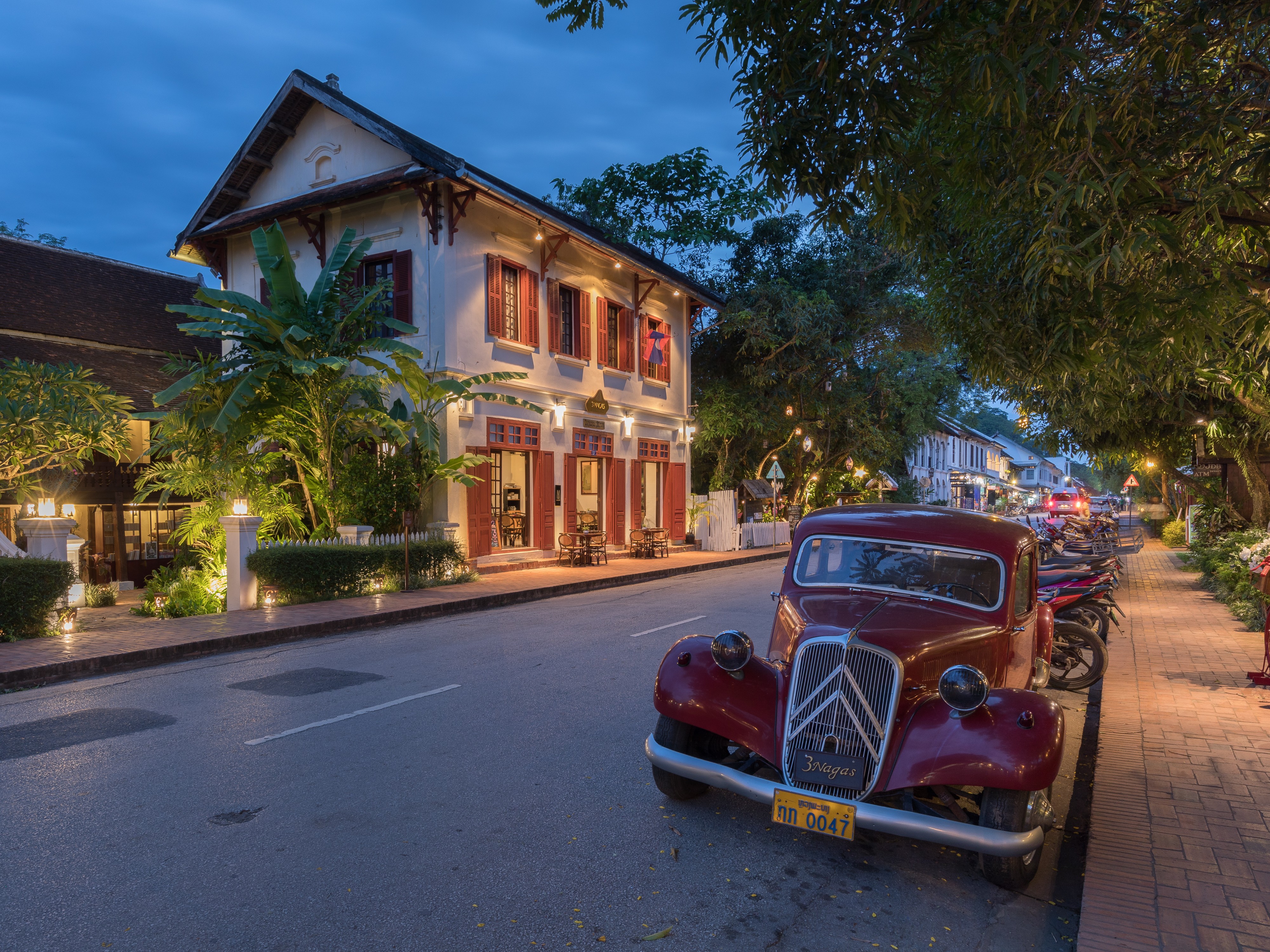 Old red Citroen near hotel 3 Nagas at blue hour in Luang Prabang