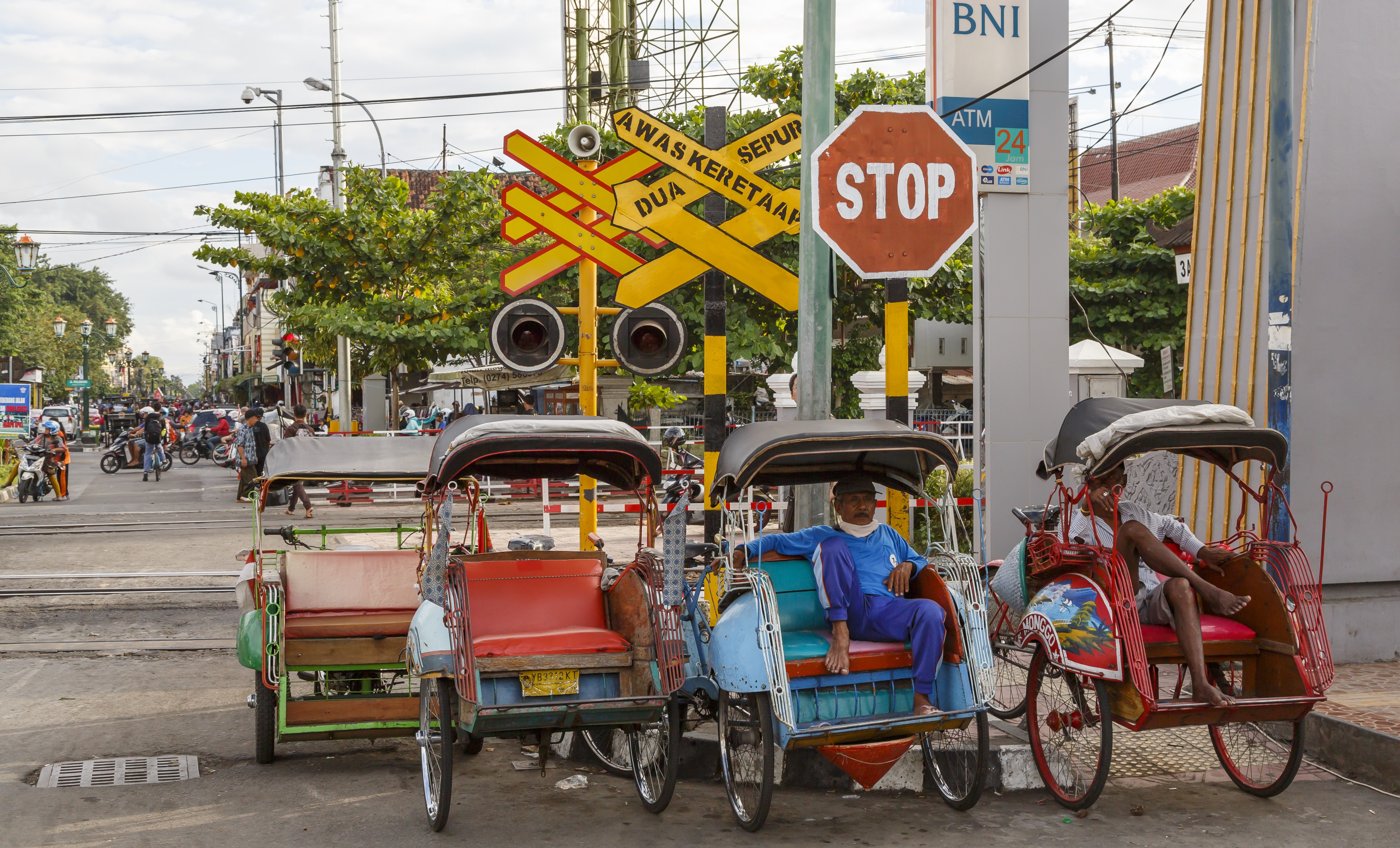 Yogyakarta Indonesia Rickshaws-waiting-at-level-crossing-for customers-01