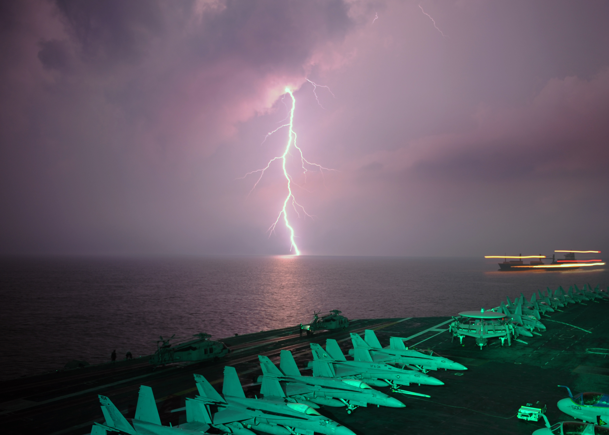 Lightning flashes in view of the aircraft carrier USS Abraham Lincoln (CVN-72)