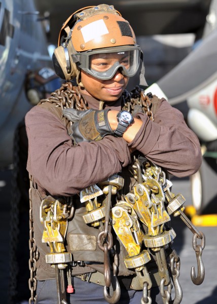 Defense.gov News Photo 120120-N-YB753-016 - A plane captain carries tie-down chains across the flight deck of the aircraft carrier USS Abraham Lincoln CVN 72 in the Arabian Sea on Jan. 20