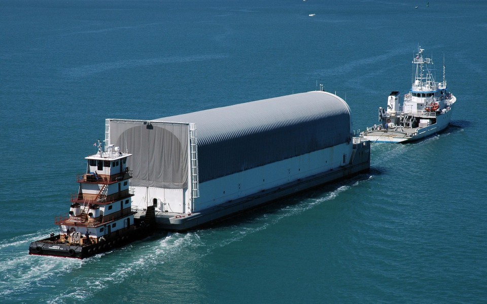 Pegasus barge being moved by Freedom Star and towboat American 1