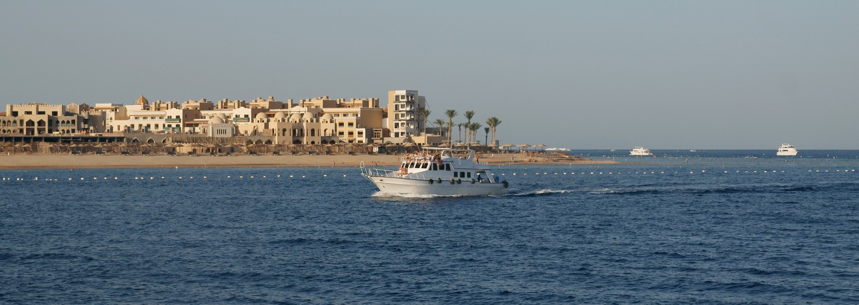 Tip of Makadi Bay with cruising boat